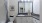 bathroom with a large mirror and walk-in shower