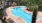 a pool with chairs and palm trees